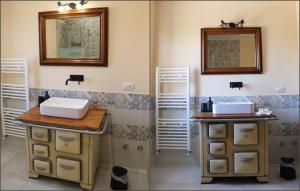 a bathroom with two sinks and a mirror at Cascina Angelina in Casteggio