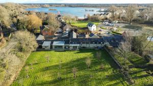 an aerial view of a large house with a yard at Lakeside property with spa access on a nature reserve Ruby Cottage MV04 in Somerford Keynes