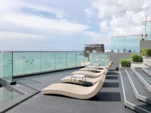 a row of benches on the roof of a building at Edge Central Pattaya By Alice in Pattaya