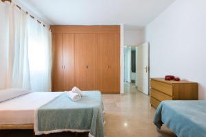 A bed or beds in a room at NEW ROYAL TORREQUEBRADA BEACH ideal for families & groups