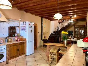 a kitchen with a white refrigerator and a table at Elegant Villa in Cartagena with Private Pool in Cartagena