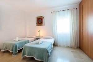 A bed or beds in a room at NEW ROYAL TORREQUEBRADA BEACH ideal for families & groups