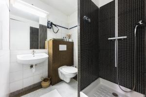 a bathroom with a toilet and a sink and a shower at ROOM SAUVAGE in Vincennes
