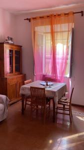 a dining room with a table and chairs and a window at ROME SWEET ROME - close to line A San Giovanni in Rome