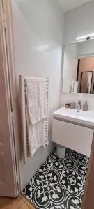 uma casa de banho com um lavatório e um espelho em Appartement deux chambres - Garibaldi em Lyon