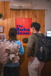 two people standing in a room looking at a sign at Buba House in Barcelona
