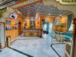 a living room with an ornate ceiling and a fireplace at Royal Victoria - Ex British Embassy in Tunis