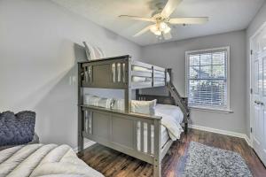 a bedroom with a bunk bed and a ceiling fan at Auburn Home with Private Yard Less Than 4 Mi to Campus! in Auburn