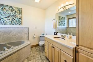 a bathroom with a sink and a toilet and a mirror at Family-Friendly Cabin By Golf Course and Marina in Holiday Island +32 photos