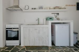 a kitchen with a sink and a stove at Elia suites in Ialysos