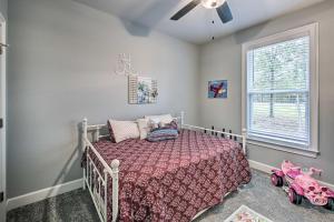 a childs bedroom with a bed and a window at Golf Course View Hot Springs Village Home! in Hot Springs Village