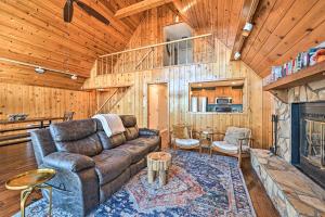 a living room with a couch and a fireplace at Spacious Franklin Cabin w/ Mountain Views! in Franklin
