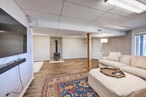 a living room with a couch and a fireplace at Spacious Franklin Cabin w/ Mountain Views! in Franklin