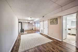 an empty room with wooden floors and white walls at Spacious Franklin Cabin w/ Mountain Views! in Franklin