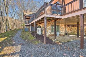 a house with a balcony on top of it at Spacious Franklin Cabin w/ Mountain Views! in Franklin
