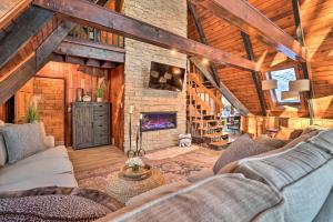 a living room with a couch and a fireplace at Rustic LaFayette A-Frame Cabin with Game Room! 