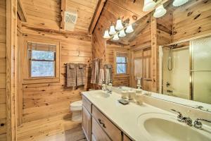 a bathroom with a tub and a sink and a toilet at Walk to Golfing Grand Maggie Valley Cabin! in Maggie Valley +24 photos