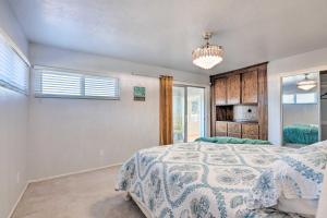 a bedroom with a bed and a chandelier at Retro House with Deck and Arroyo Grande View in Arroyo Grande