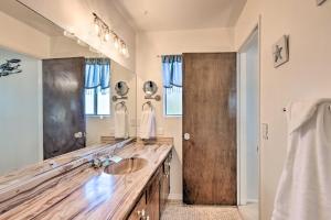 a bathroom with a wooden counter and a sink at Retro House with Deck and Arroyo Grande View in Arroyo Grande +27 photos