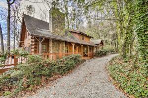 a log cabin with a gravel road in front of it at Walk to Golfing Grand Maggie Valley Cabin! in Maggie Valley