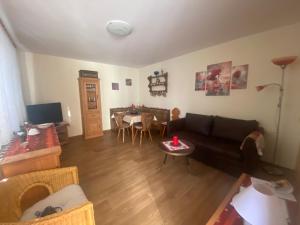 a living room with a couch and a table at Fewo Radebeul Altkötzschenbroda in Radebeul