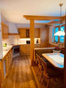 a kitchen with wooden cabinets and a table with chairs at Haus Lawerz in Nauders