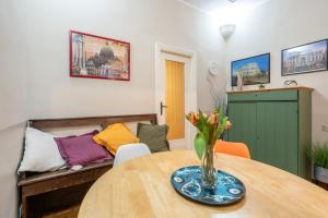 a living room with a table and a couch at Colosseo Ohana Suite in Rome