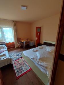 a bedroom with a large bed in a room at Edelweis Floare de Colt in Borsec