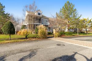 a house on a street with a driveway at Sea Colony --- 56065 Pinewood Drive in Bethany Beach