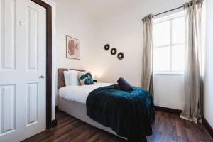 a bedroom with a bed and a large window at Deluxe suite- 2 bed in Southampton Central in Southampton