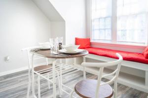 a dining room with a table and a red bench at Charming Carriage Cottage from 1920s in Oklahoma City