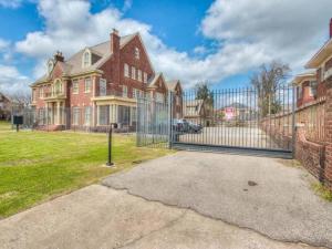 a large red brick house with a gate in the yard at Historic 1920s Brick Beauty in Medical District in Oklahoma City
