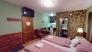 a hotel room with two beds and a kitchen at Ride Pub Drienica in Drienica +22 photos