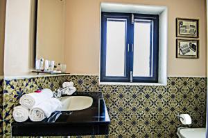a bathroom with a sink and a window at Sonaar Haveli in Jaisalmer