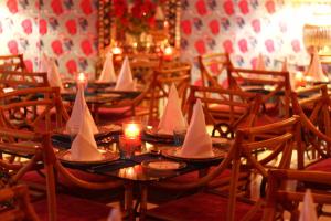 a dining room with tables with paper boats on them at Sonaar Haveli in Jaisalmer