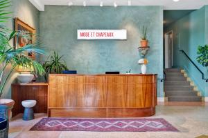 a reception desk in a lobby with plants at Hotel Trouvail Miami Beach in Miami Beach