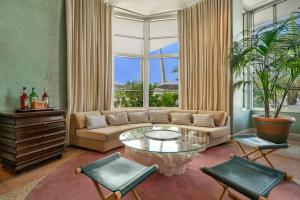 a living room with a couch and a glass table at Hotel Trouvail Miami Beach in Miami Beach