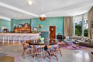 a living room with a table and chairs at Hotel Trouvail Miami Beach in Miami Beach