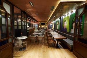 a row of tables and chairs in a restaurant at Veritas Boutique Art Hotel in Veria