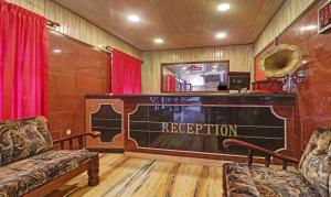 a room with a bar with a sign that reads reception at Itsy By Treebo - Hill Town 500 Mtrs From Madikeri Fort in Madikeri