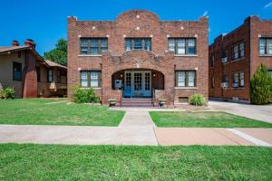 a large brick building with a blue door at Elegant and Historic Getaway Close to Everything in Oklahoma City