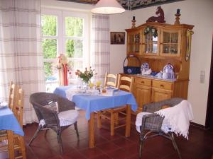 a kitchen with a table with a blue table cloth at Moorberghof in Sagau