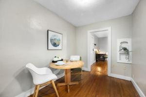 a dining room with a wooden table and white chairs at Elegant and Historic Getaway Close to Everything in Oklahoma City