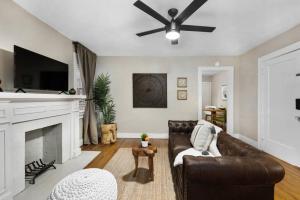 a living room with a couch and a fireplace at Elegant and Historic Getaway Close to Everything in Oklahoma City