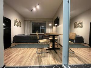 a bedroom with a bed and a table and chairs at Northern Lights Center Apartment 2 in Rovaniemi