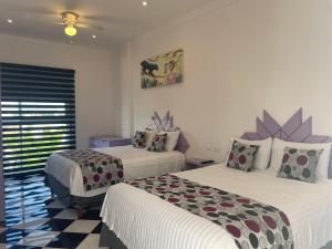 a hotel room with two beds and a window at WINDAY HOTEL - Cerca 5a Avenida in Playa del Carmen