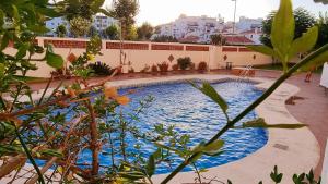 a large swimming pool in the middle of a building at Vivienda Turística Playa El Portil in El Portil