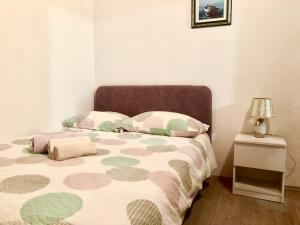 Postel nebo postele na pokoji v ubytování Nar Apartment