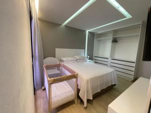 a small bedroom with a bed and a mirror at Chartres Charming Residence in Fortaleza