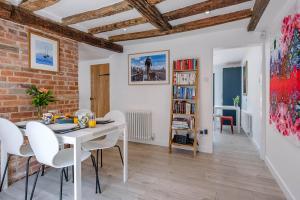 a dining room with a white table and white chairs at Hall Cottage Woodbridge Air Manage Suffolk in Woodbridge